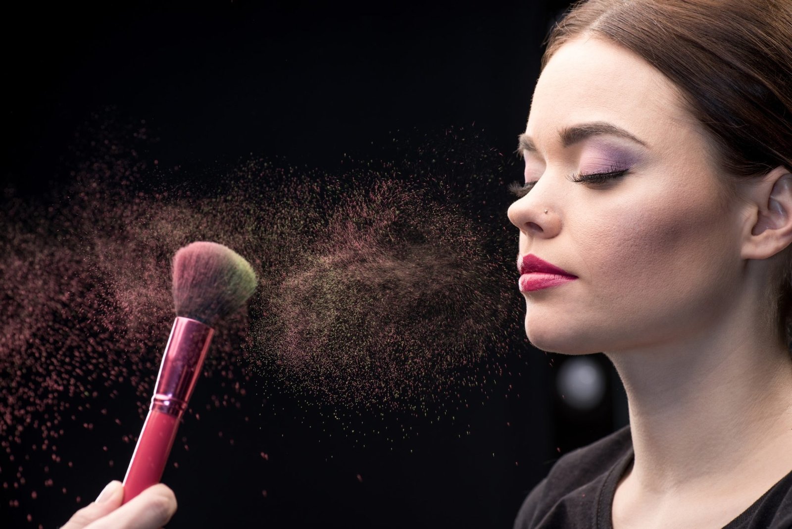 Home 7 make-up-artist-sprinkling-model-s-face-with-powder-with-help-of-brush-on-black.jpg